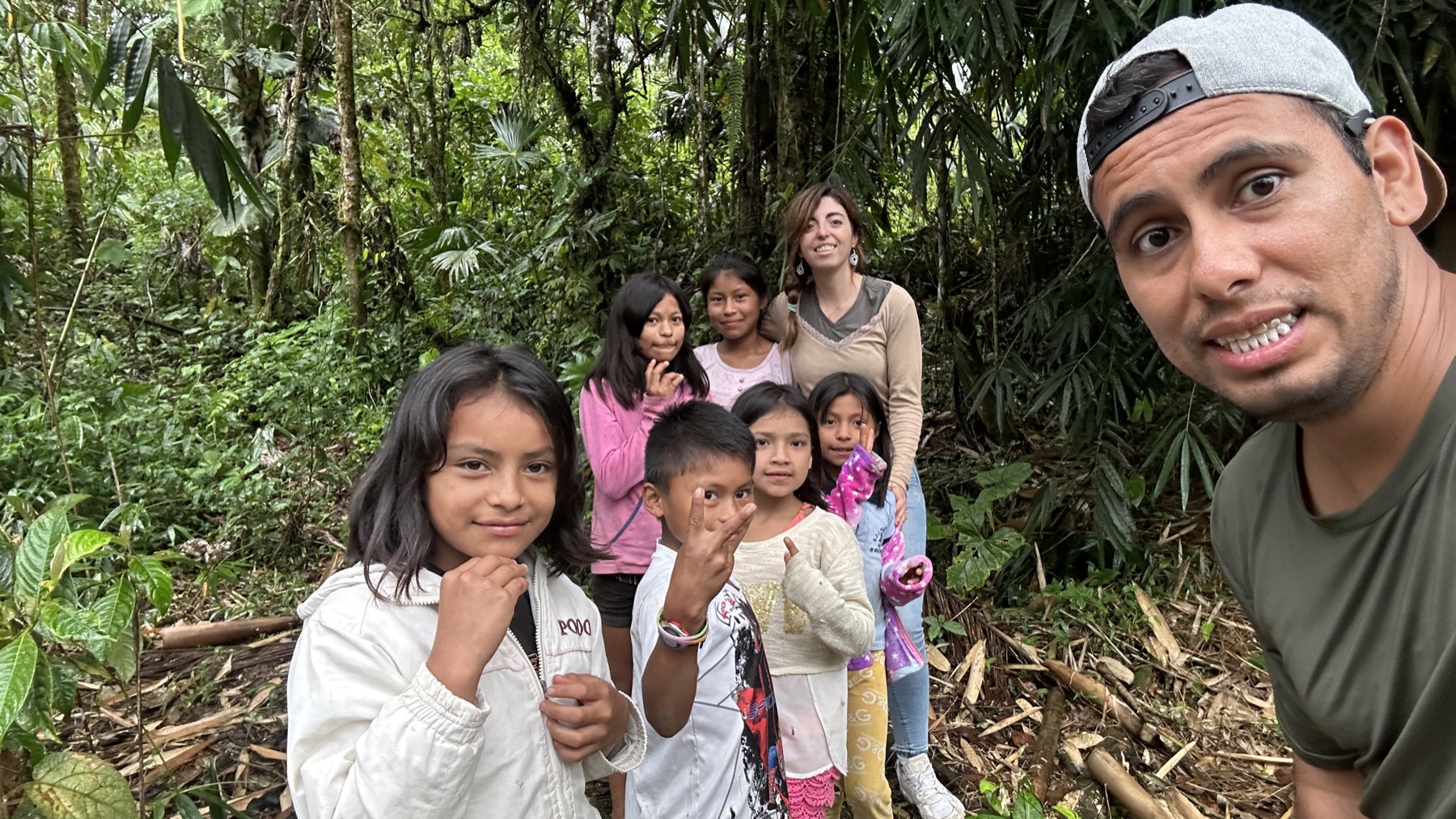 Raul sharing a moment with a group of children outdoors